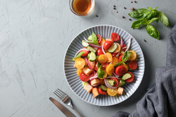 Tuscan Panzanella with tomatoes and bread. Top view. Traditional Italian cuisine. Vegetarian panzanella salad. Mediterranean healthy food.
