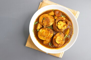 Indian non-vegetarian food- Homemade Egg Curry or Anda masala gravy, baida curry. Indian spicy food. Perfect Indian lunch. over moody background with copy space. - obrazy, fototapety, plakaty