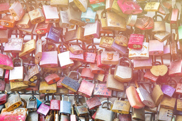 Closed fastened metal wedding locks fastened on bridge in Cologne