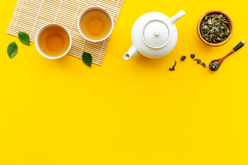 Asian food and drink background white teapot and black tea in two cups