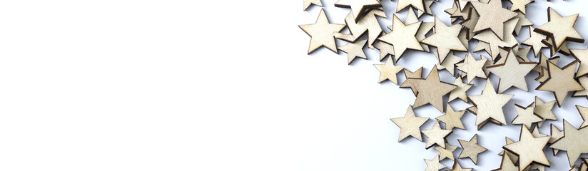 A lot of wooden stars on a white background. Copy Space.