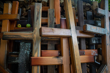 stack of old christian crosses near cemetery in Latvia, abandoned catholic and orthodoxal symbols. Two apples