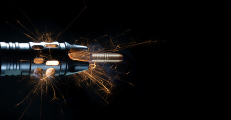 Copper bullet and sparks with smoke coming from the muzzle of an AR-15