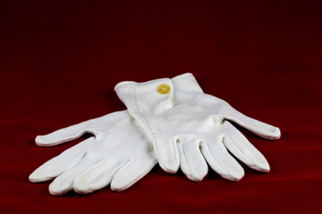 White Gloves Isolated on a Red Table Cloth