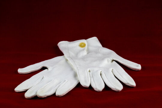 White Gloves Isolated on a Red Table Cloth