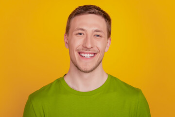 Photo of young cheerful man happy positive smile confident cool isolated over yellow color background