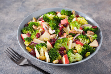 healthy broccoli salad with apple onion dried cranberries pistachio. vegan low carb diet - Powered by Adobe
