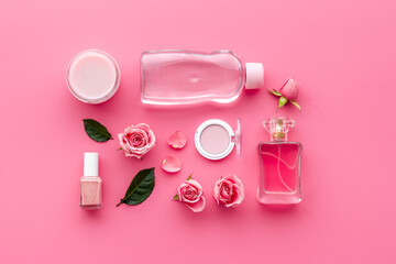 Obraz na płótnie Canvas Pink roses cosmetic set with aroma oil and flower perfume