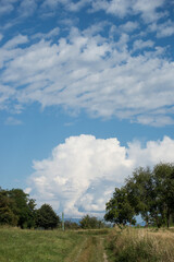 View of countryside landscape with cloudy sky on background