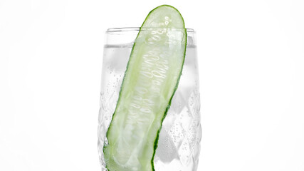 Water with sliced cucumber on white background. Detox drink water with cucumber and ice. Cucumber infused water