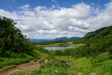 Fototapeta na wymiar Landscape. hiking trail from the slope of the Vachkazhets volcano to the mountain lake Tahkoloch. Kamchatka Peninsula