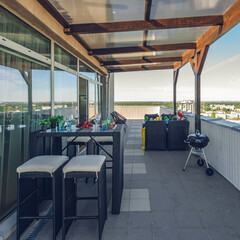 Lounge zone on outdoor terrace in modern luxury apartment.