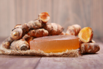 turmeric root and herbal soap on table 