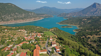 Fototapeta na wymiar Aerial drone photo of small picturesque village of Lidoriki built near lake and dam of Mornos a clean water supply for Attica, Greece
