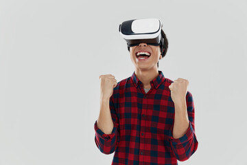 Smiling asian man using virtual reality glasses