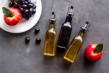 Red wine and apple cider vinegar with grapes and red apples