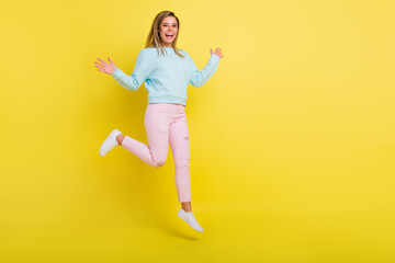 Fototapeta na wymiar Full length body size view of pretty cheerful girl jumping walking having fun copy space isolated over bright yellow color background