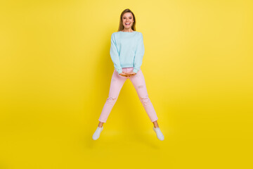 Fototapeta na wymiar Full length body size view of attractive lucky cheerful girl jumping having fun isolated over bright yellow color background