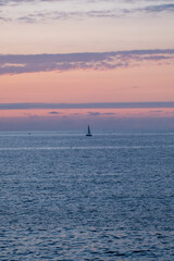 sailboat in the sea at sunset