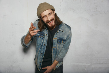 Young joyful european man gesticulating at camera