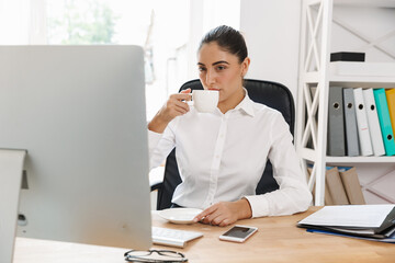 Happy mid aged businesswoman at the desk