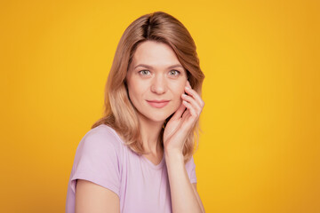 Portrait of charming tender dream lady natural sensual pose hand cheekbone on yellow background