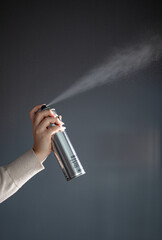 hair stylist demonstrates hair products, hairspray sprinkles in the air, a hair stylist and his tools, a stylist's content shoot