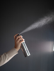 hair stylist demonstrates hair products, hairspray sprinkles in the air, a hair stylist and his...