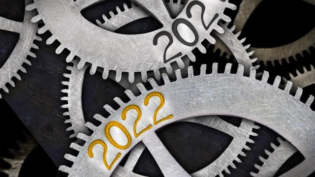 Tooth wheels in forward and backward rotation with number 2022 incoming and 2021 passing. New Year concept. High quality 4k video.