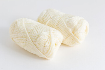 Fototapeta na wymiar white woolen yarn close-up on a white table. Hobby knitting.