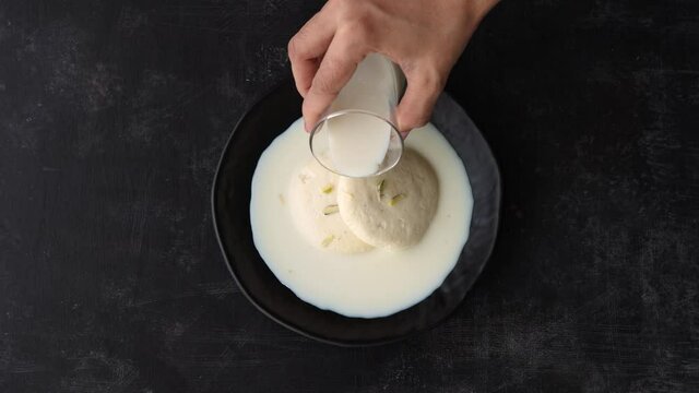Rasmalai Ras malai Rasamalei Indian Sweet dessert mithai milk sweet 4k footage video Diwali Dussehra Holi ganesh chaturthi Ram navami Durga pooja ashtami Navratri festival Mumbai Bengal India Pakistan