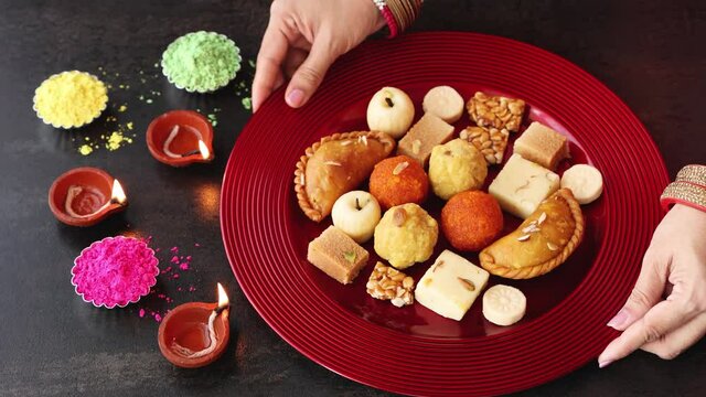 Indian woman serve Diwali sweets Gujiya peda barfi Indian Sweet dessert mithai 4k, footage festival Dussehra Holi ganesh chaturthi Ram navami Durga pooja, durga ashtami Navratri Mumbai Kerala India