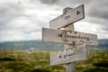 do something great quote text on wooden signpost outdoors in nature.
