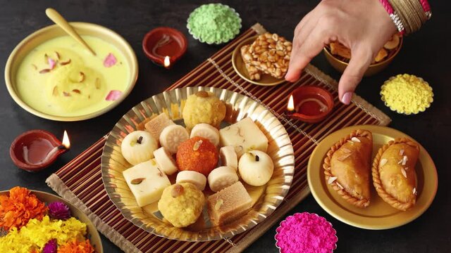 Indian woman serve Diwali sweets Gujiya peda barfi Indian Sweet dessert mithai 4K footage festival      Dussehra Holi ganesh chaturthi Ram navami Durga pooja durga ashtami Navratri Mumbai India 