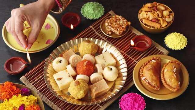 Indian woman serve Diwali sweets Gujiya peda barfi Indian Sweet dessert mithai festival dish Dussehra Holi ganesh chaturthi Ram navami Durga pooja, durga ashtami Navratri Mumbai Kerala India Sri Lanka