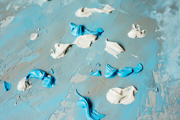Obraz premium Abstract background from brush strokes of blue and gray paints and putty.