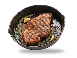 Delicious juicy pork steak with garlic and rosemary in a cast iron pan.