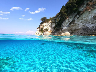 Fototapeta premium Underwater sea level split photo of beautiful paradise turquoise exotic beach of Voutoumi probably the best in Greece, Ionian island of Antipaxos