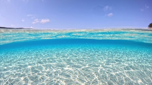 Underwater sea level split photo of beautiful paradise turquoise exotic beach of Voutoumi probably the best in Greece, Ionian island of Antipaxos