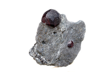 Fototapeta premium Macro mineral stone garnet in the rock on a white background