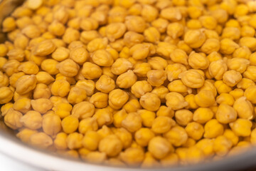 Chickpeas in a bowl are soaked in water
