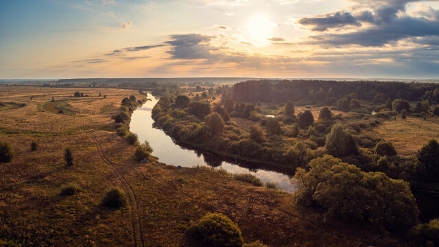 Bright morning on river Snov, Chernihiv regiron, Ukraine. Drone landscape of river going in the countryside