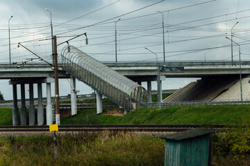 aboveground pedestrian crossing. stairs for people to cross over railway tracks. engineering...