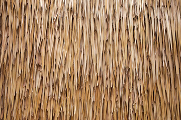Brown hay roof is stacked on top of each other as a textured background.