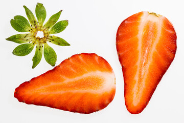 Half-sliced strawberry with the calyx isolated on a white surface