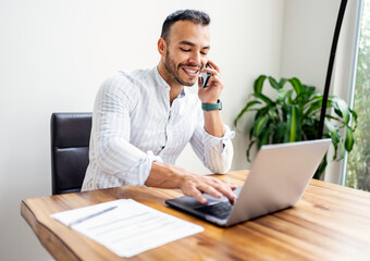 Portrait young mexican attractive businessman working at modern home office with computer laptop