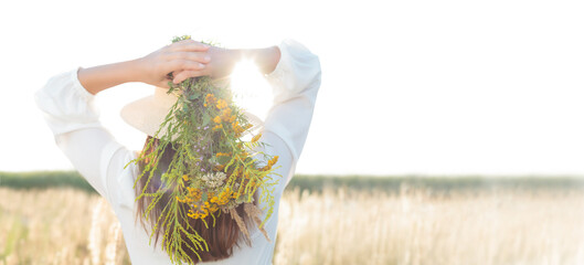A woman holding a bouquet of herb, a natural medicine. Hair care - banner. Natural medicinal...