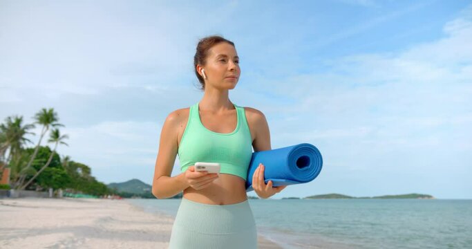 woman enjoys the morning after exercise, she takes a deep breath and close her eyes with joy