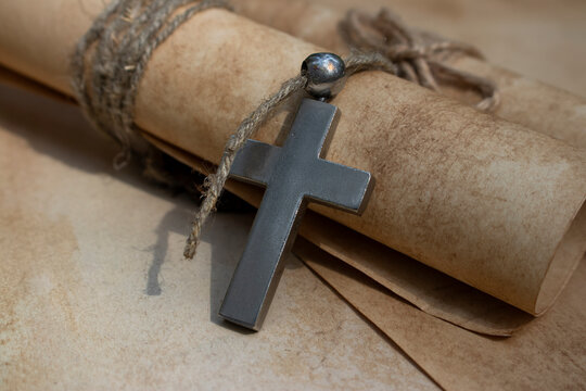 Cross and medieval scrolls.
