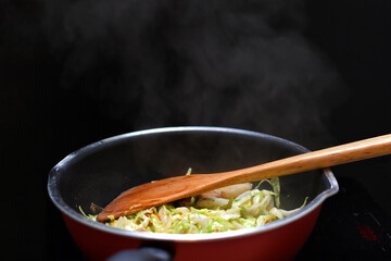 Stir Fried Mixed Vegetable in teflon pan heat source by induction cooker.